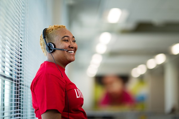 smiling woman with a headset on