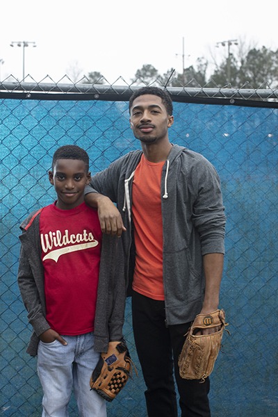 man and boy with baseball mitts