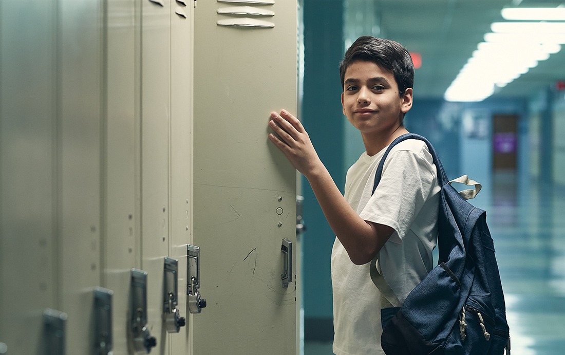 child standing at his locker