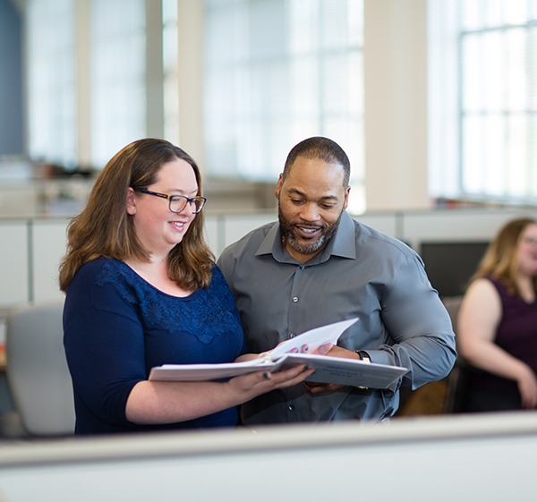 man and woman reviewing papers